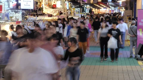 Bustling crowd moving through Hongdae shopping street, time lapse at night Stock Footage 289035125