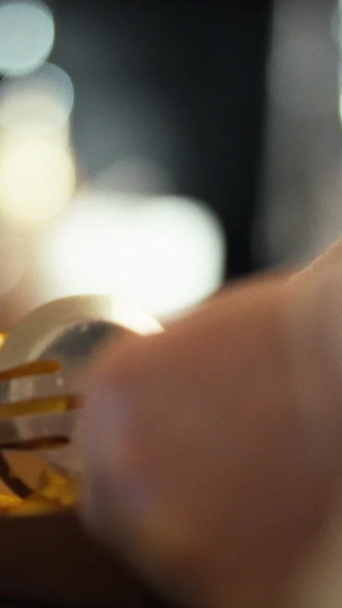 In bustling lunch-time eatery a worker deftly grips hot fries with metal ton Stock Footage 331795158