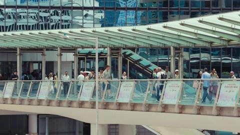 A bustling modern pedestrian walkway in a large contemporary building with glass Stock Footage 338311442