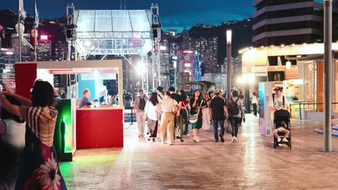 A bustling night scene at Tsim Sha Tsui's Avenue of Stars in Hong Kong. The Stock Footage 338280354