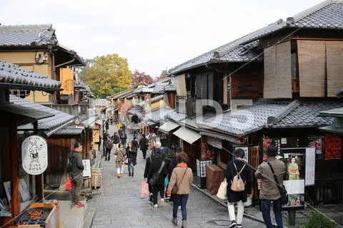 Bustling pedestrian street on a hill lined Stock Photos