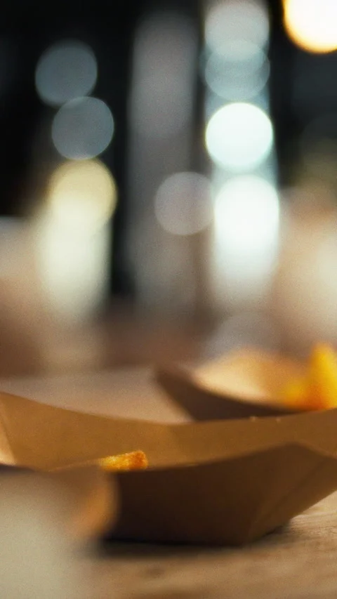 At a bustling restaurant kitchen a chef arranges golden crispy fries on a se Stock Footage 331794595