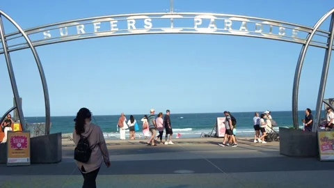 A bustling scene of beach life, the iconic Surfers Paradise archway entrance 動画素材 325163083