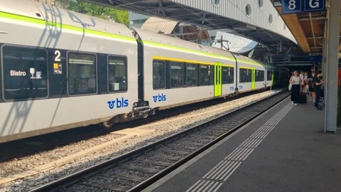 Bustling scene at Bern Central Station on a sunny summer day, as passengers Stock Footage 344489710