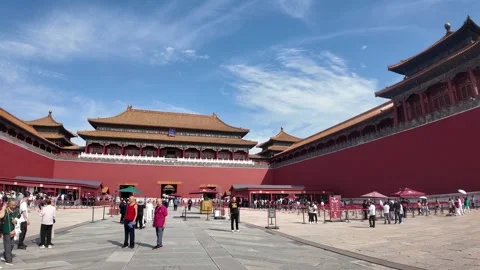 A bustling traditional Chinese architectural complex under a bright, sunny sky Stock Footage 337306189