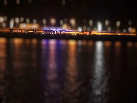 Bustling traffic on the waterfront at night Stock Footage 71863944