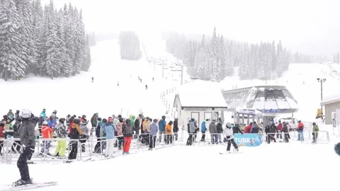 Bustling Winter Resort: Skiers Queue for Lift, BC, Canada, Jan 2023 Stock Footage 253121428