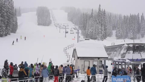 Bustling Winter Resort: Skiers Queue for Lift, BC, Canada, Jan 2023 Stock Footage 253121599