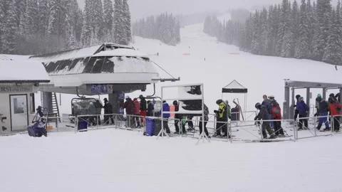 Bustling Winter Resort: Skiers Queue for Lift, BC, Canada, Jan 2023 Stock Footage 253121718