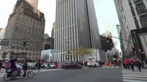 A busy and bustling urban intersection surrounded by impressive skyscrapers in 스톡 동영상 295073873