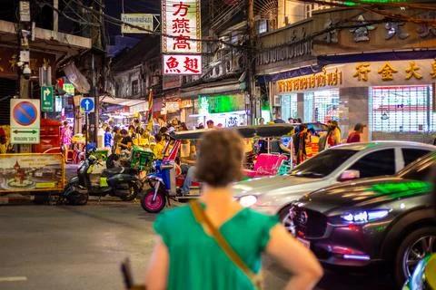 A busy and congested street intersection in an Asian city at night, filled with Stock Photos