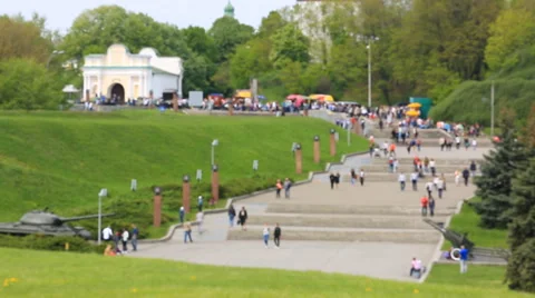 Busy anonymous people out of focus are walking in the park Stock-Footage 63136342