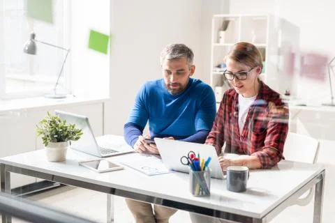 Busy app developers using modern devices Foto stock