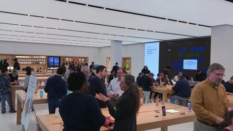 Busy Apple Store Scene with Customer/Employee Interactions Stock Footage 168334088