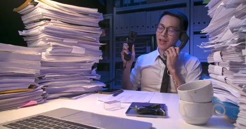 Busy asian man is working multi tasking and holding many telephone at late night Video stock 230461407