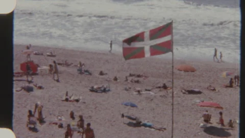 Busy Beach Scene With Basque Flag Waving Stock Footage 321320309