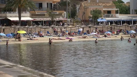 Busy beach by a small town Stock Footage 128348289