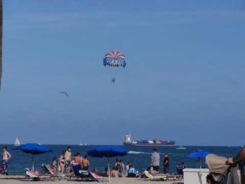 Busy beach view with a cargo ship in the distance,Fort Lauderdale, Miami Stock Photos