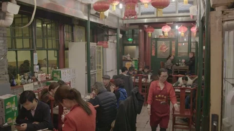 Busy Beijing Restaurant Interior With Diners Eating and Staff Serving Food Stock Footage 345771003