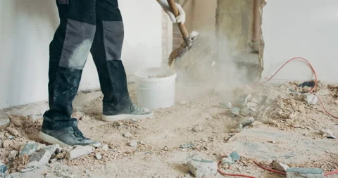 Busy builder collecting construction debris with a shovel. Home renovation Stock Footage 219715479
