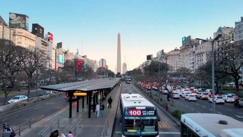 Busy bus lane and rush hour car traffic in Buenos Aires, 9 de Julio Avenue Stock Footage 219983938