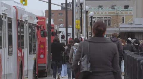 Busy bus stop with many pedestrians 스톡 동영상 24581128