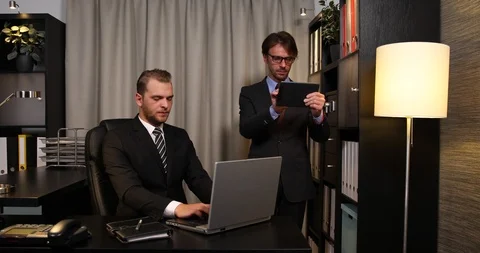 Busy Business Men Working on Computer Tablet and Laptop Teamwork Activity Office Stock Footage 87936498