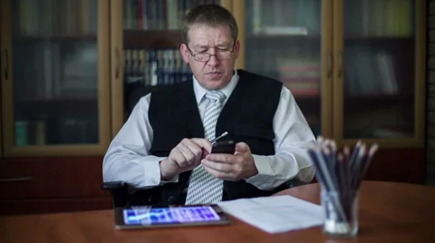 Busy businessman working with laptop documents, smartphone and tablet Stock-Footage 31804009