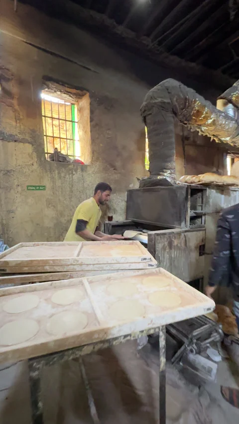 A busy Cairo bakery baking Aish Baladi Stock Footage 305899123