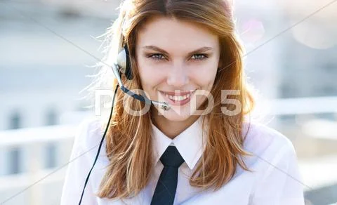 Busy call center agent speaking hands free Stock Photos