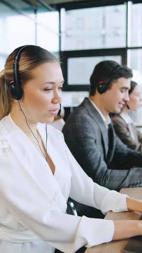 Busy call center team assisting clients with technical support and financial Stock Footage 320910461