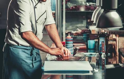 Busy chef at work in the restaurant kitchen Stock Photos