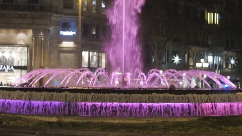 Busy city centre traffic intersection night lights crowd cars fountain Stock Footage 73185151