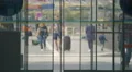 Busy city life, view on pedestrians through airport doors, tourism and travel 4k or 4k+ Resolution