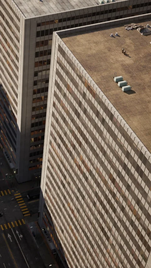 In a busy city, workers are seen on the rooftop of a tall building Stock Footage 342190985