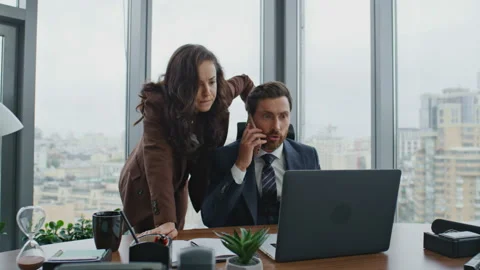 Busy colleagues solving problems on phone conversation at office. Couple working Stock Footage 227957792