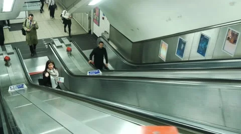 Busy commuters on elevators of an underground station in London. Stock Footage 65006547
