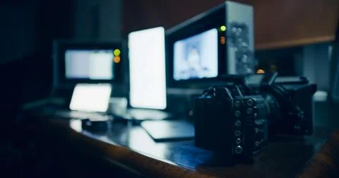 Busy computer workplace at night with a camera Photos