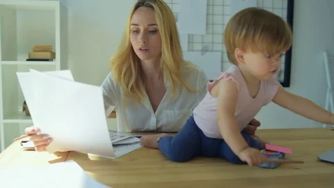 Busy concentrated mom working at home Stock Footage