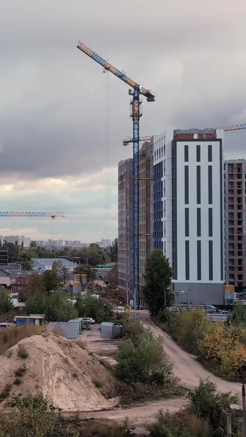 Busy Construction Scene with Moving Cranes and Cloudy Skies. Time-lapse. Ve.. Stock Footage 288843117