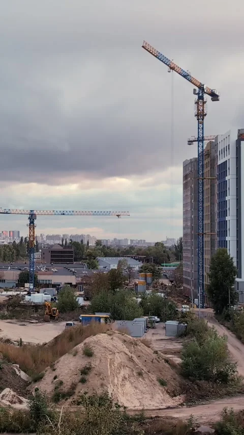 Busy Construction Scene with Moving Cranes and Cloudy Skies. Time-lapse.  V.. Stock Footage 289820050