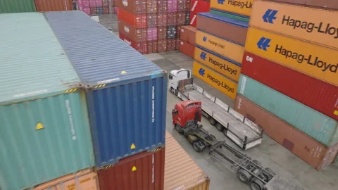 A busy container port featuring towering stacks of cargo containers and trucks Stock Footage 318924034