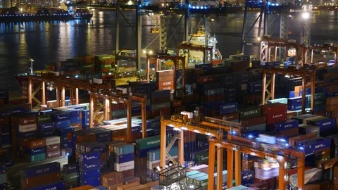Busy container terminal, time lapse shot at night time, medium telephoto view Stock Footage 99597795