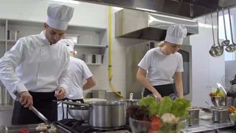 Busy cooks and kitchen chef working in professional kitchen Stock Footage 102742673