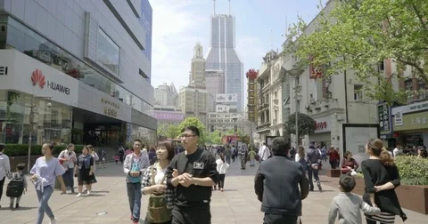 Busy, Crowded Street with Skyline Background in the Heart of Shanghai, China 4K. Video stock 80389210