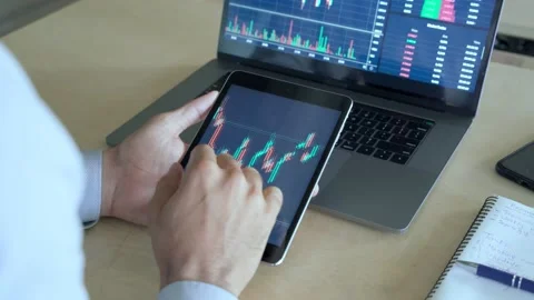 Busy crypto trader using tablet analyzing digital stock market trading chart. Stock Footage