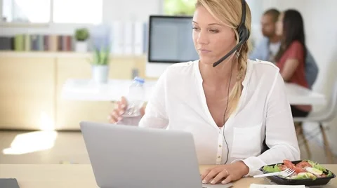 Busy customer service manager eating lunch in office Stock Footage