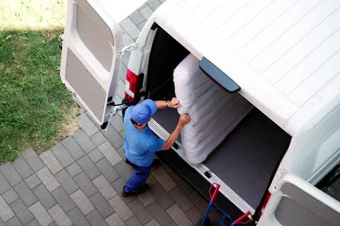 Busy Day: Mover Carrying Boxes Into New Home With Truck Photographer Capturin Stock Photos