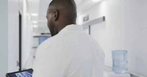 Busy diverse doctors using tablet and talking in hospital in slow motion Stock Footage 337932369