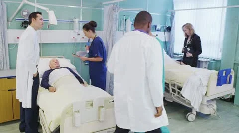 Busy doctors and nurses taking care of patients on a hospital ward Stock Footage 20457938
